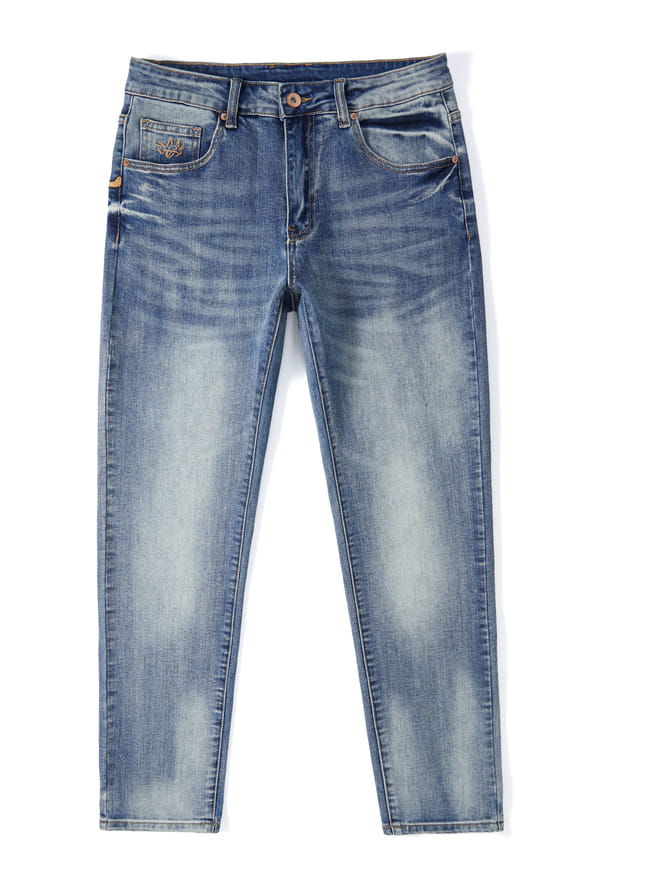 Slim tapered jeans in light blue denim with hand-finished whiskering